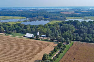 beautiful aerial view of farm with river in background